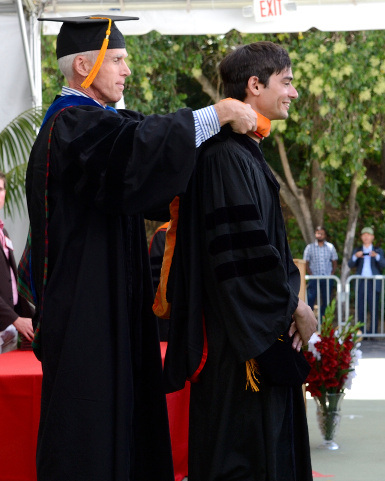 Ousterhout placing academic hood on Ongaro